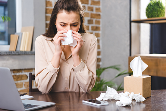 Businesswoman suffering from allergies at her workplace in Winter Haven FL